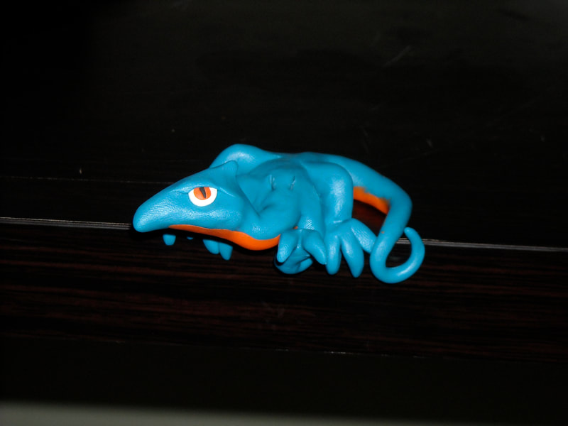 Blue polymer dragon with an orange belly