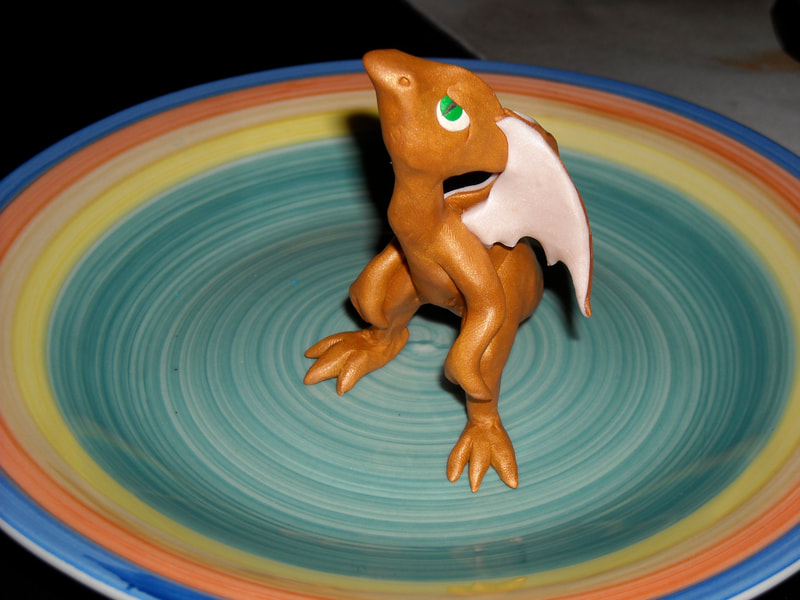 A small standing gold polymer dragon