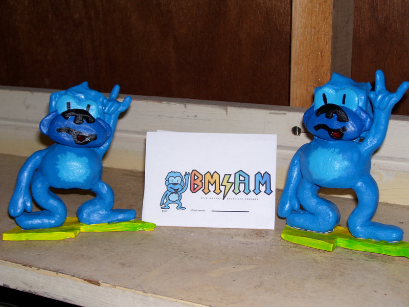 Two blue acrylic painted clay cartoon apes