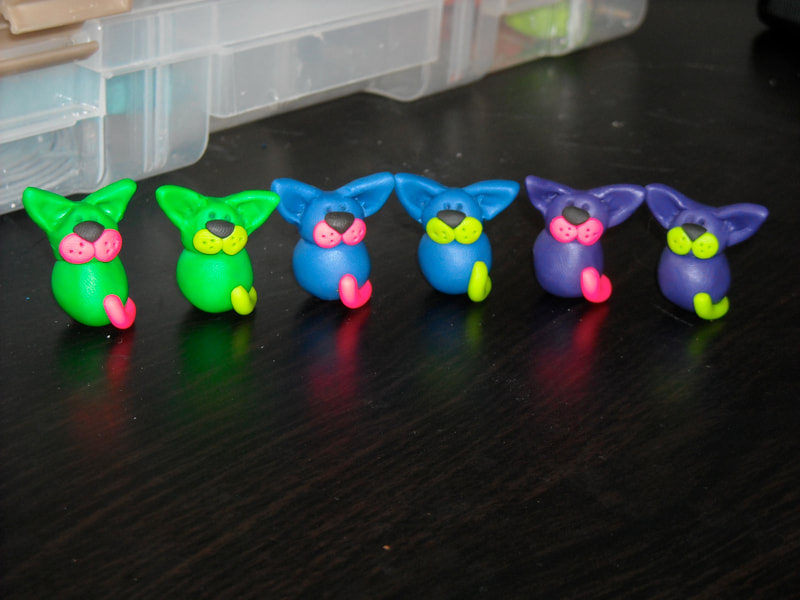 Brightly coloured cartoony cat magnets made of polymer clay