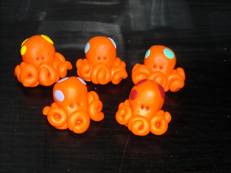 Polymer clay octopus magnets, orange with colourful spots