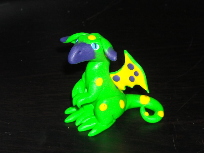 A green with yellow dots polymer dragon I named 'Spoonwinkle'