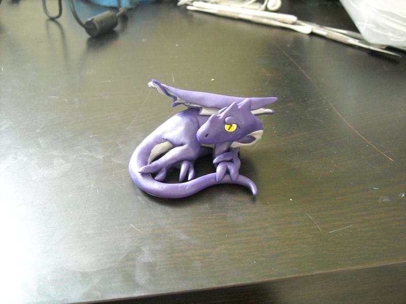 A purple with silver belly polymer clay dragon